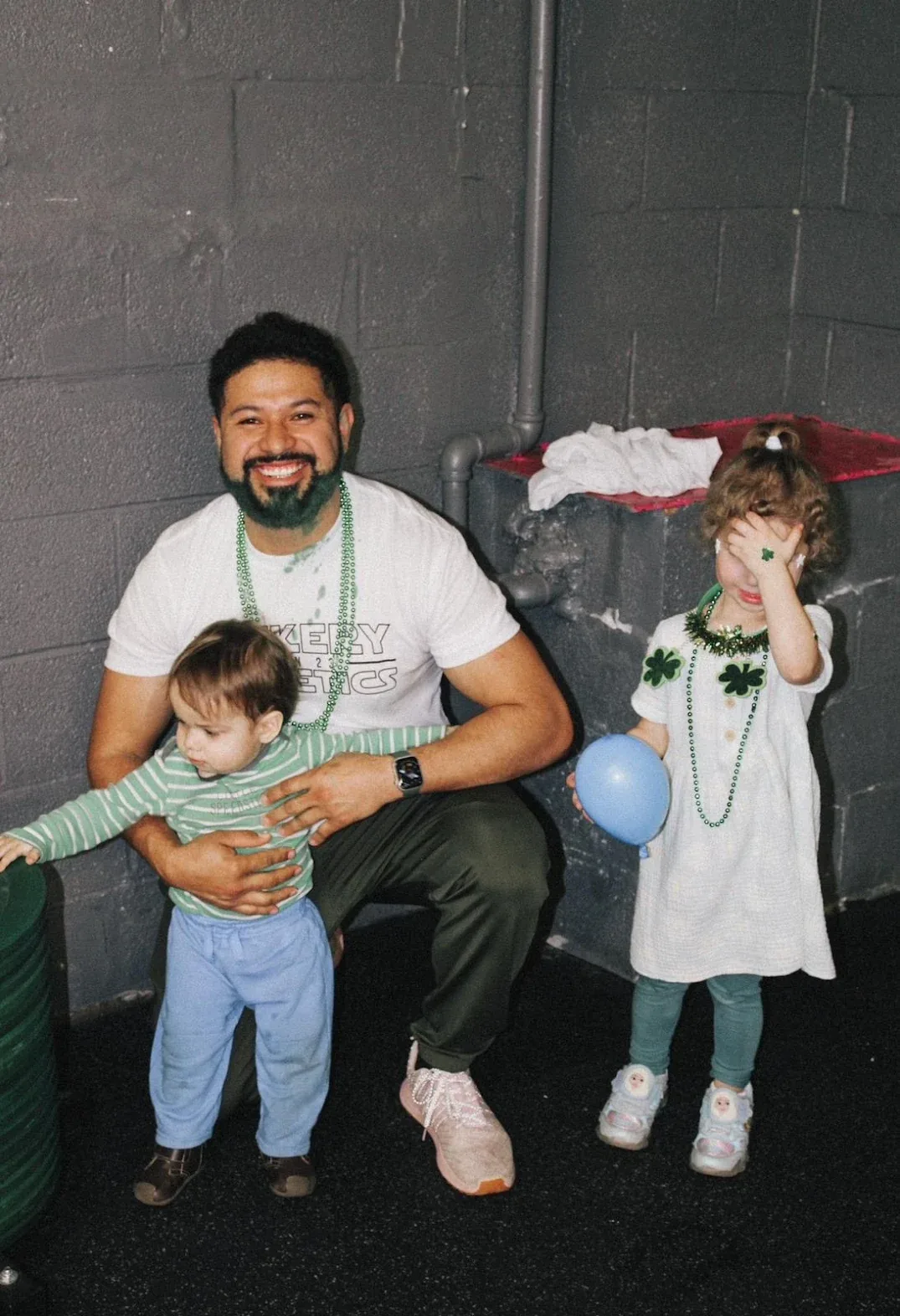 A Vickery Athletics coach with young children at a community event in East Dallas