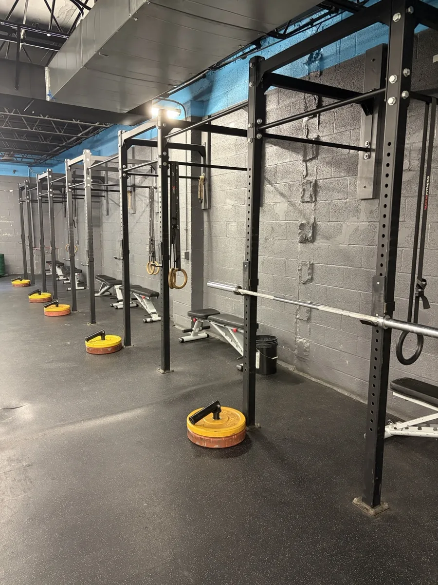 Dumbbells, kettlebells, and mobility tools in the accessory training area at Vickery Athletics, East Dallas